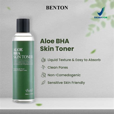 A bottle of Benton Aloe BHA Skin Toner surrounded by fresh aloe vera leaves.
