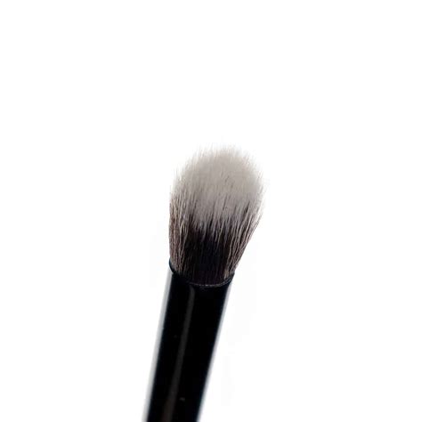 Close-up of a soft, tapered blending brush demonstrating its texture and shape.