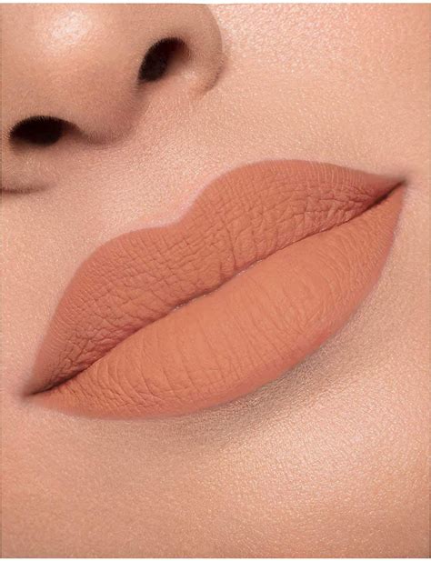 A split image showing a close-up of lips with a matte lipstick on one side and lips with a sheer, peachy lip stain on the other.