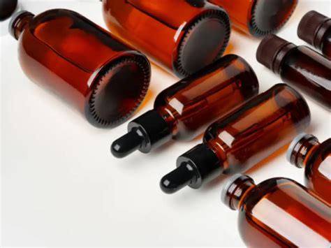 Collage of various botanical oils in amber glass bottles, with labels indicating their origin and properties.
