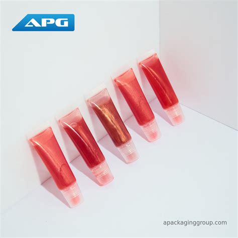 A selection of different lip gloss tubes and pots, showcasing various finishes and colors.