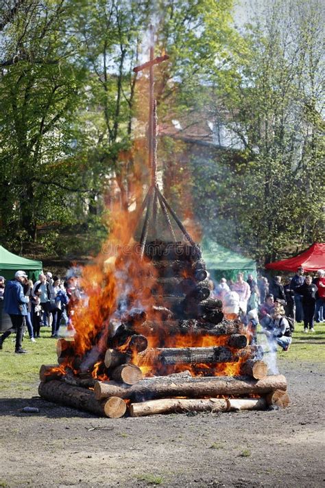 Illustration of a bonfire with people celebrating Čarodějnice in the Czech Republic