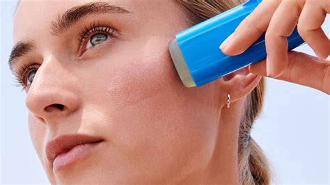 Illustration of a person applying blue sunscreen stick to their nose and cheeks.