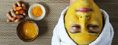 Image of turmeric powder paste being applied to skin