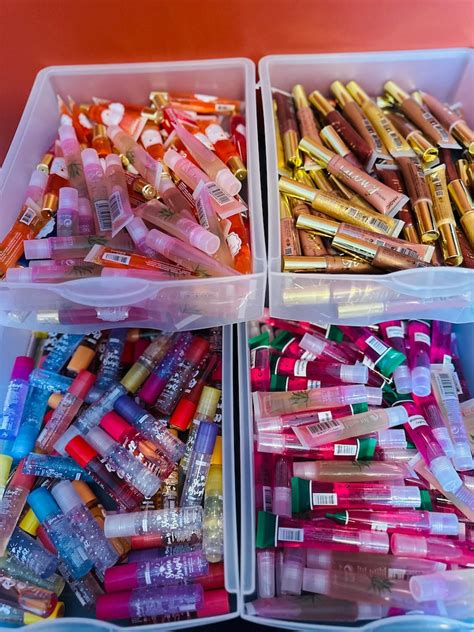 A collection of various rollerball lip glosses in different flavors and packaging