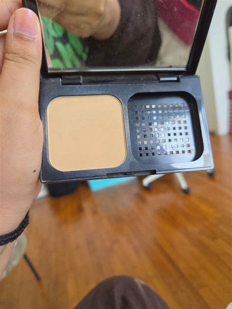 Close-up of a woman's face with a smooth, matte complexion achieved with powder foundation
