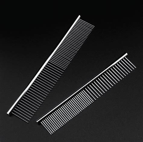 Close-up of a metal dog comb with different tooth spacings