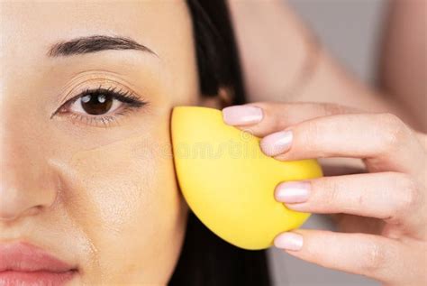 Close-up of a makeup sponge applying foundation to a child's face.