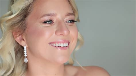 A bride with flawless HD makeup, smiling for a close-up photo.