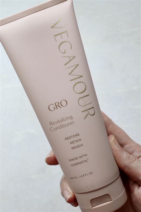 A bottle of Vegamour Gro Revitalizing Shampoo alongside a sample of hair to illustrate fullness.