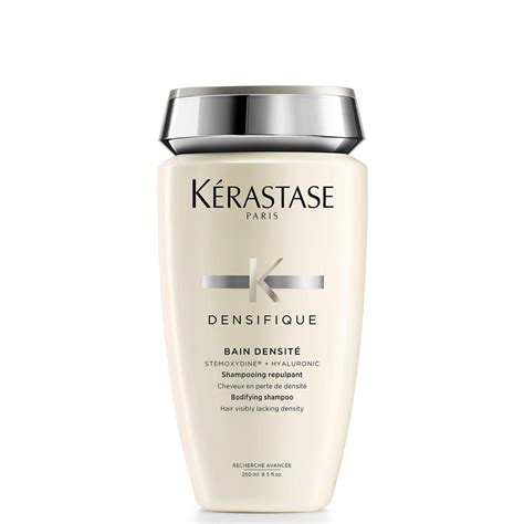 A bottle of Kérastase Densifique Bain Densité Shampoo with a focus on its texture.