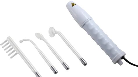 Close-up image of a high-frequency wand with a glass electrode, demonstrating its application on a blemish.