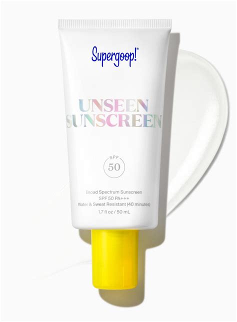 A person applying Supergoop! Unseen Sunscreen, showing its clear gel texture.