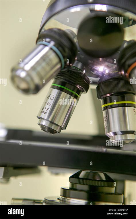 A close-up image of a microscope in a laboratory setting, representing dermatopathology.