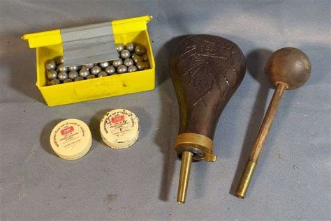 Close-up of percussion caps, lead balls, and a powder measure