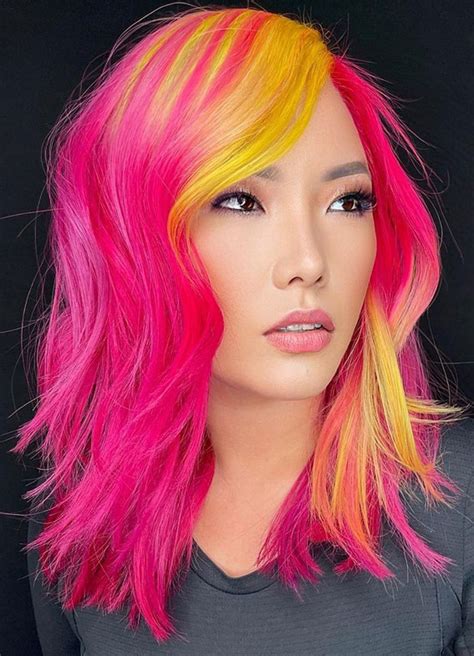 A collage of brightly colored plastic hair dryers in peach, yellow, pink, and purple.