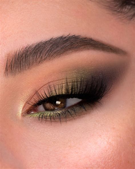 Photo of the completed makeup look, highlighting the green eye makeup and simple lips/cheeks.